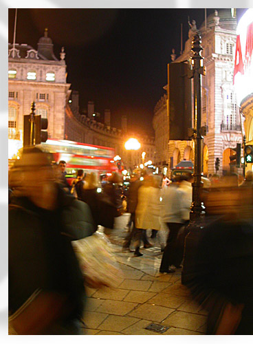 the crowds flow by at Piccadilly Circus