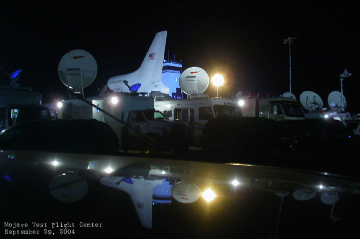 satellite trucks aim their dishes at the sky during the predawn launch preparations for the Spaceship One X1 launch