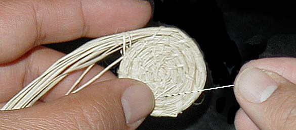 applying a needle to the beginnings of a basket...
